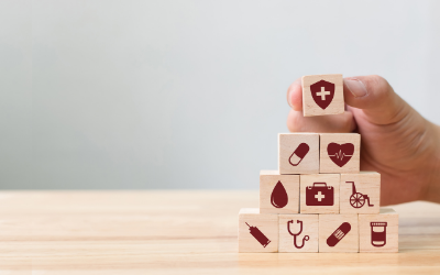 wooden blocks with icons representing different types of insurance